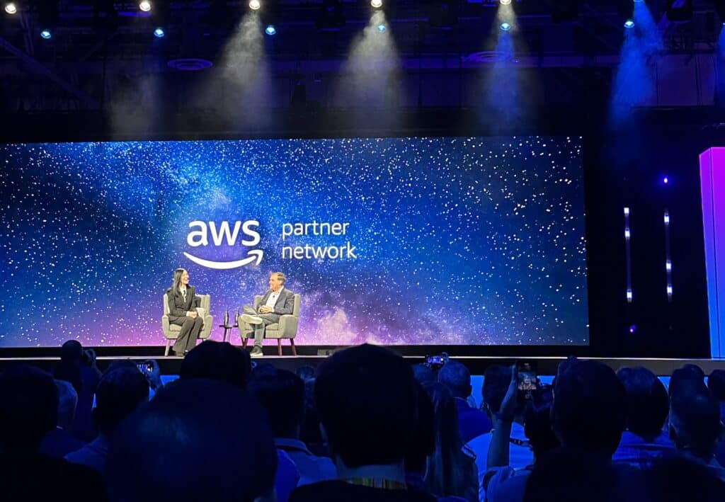 photo of speakers on stage at AWS Re:Invent event